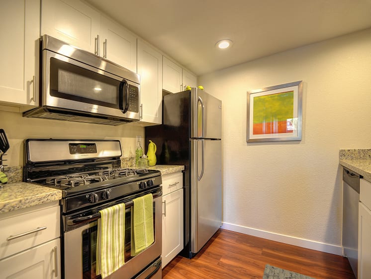 Kitchen Stove with Refrigerator, Hardwood Inspired Floor and Microwave